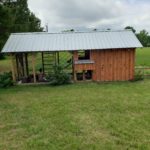 Chicken run with coop and lawn mower shed.